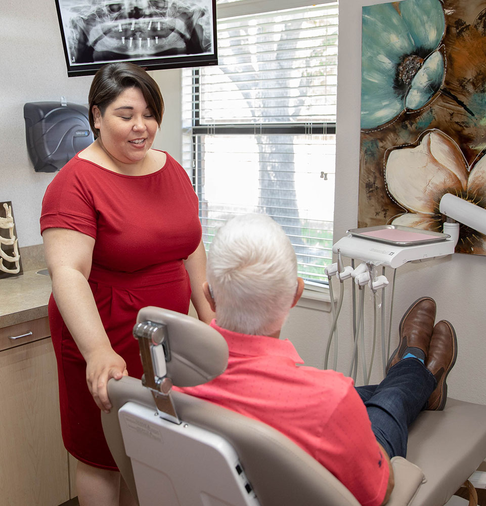 dent receptionist checking patient into exam room