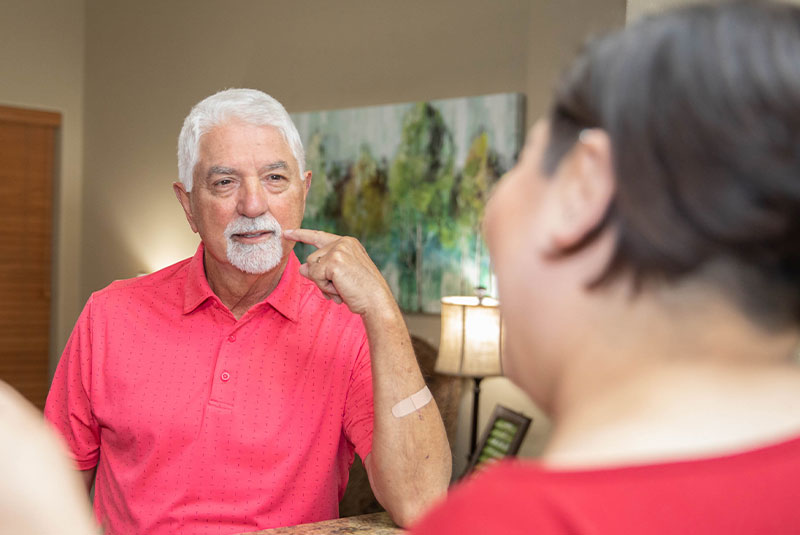 dental patient pointing at mouth for dental pain