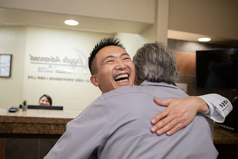 Dr. hua hugging dental patient