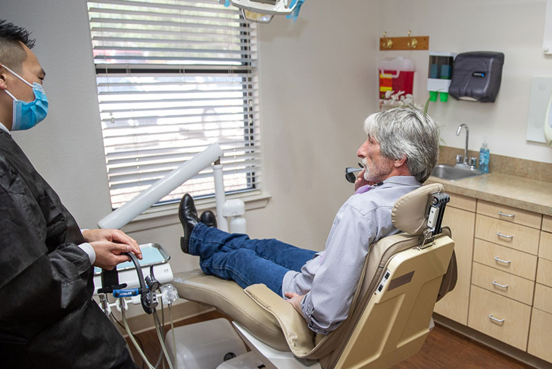dental implant patient sitting in exam chair